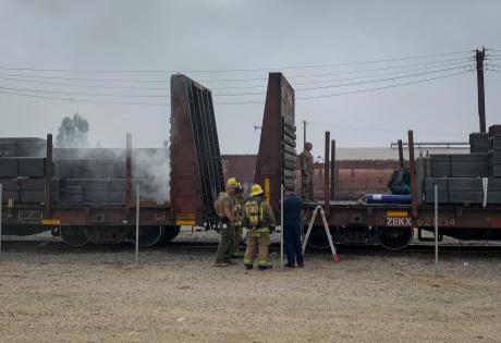Emergency responders survey the scene of a simulated railway hazardous materials incident.