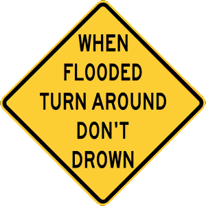 Yellow warning sign that reads "When flooded Turn Around Don't Drown."