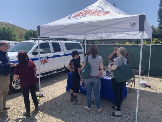 Image of 5 people with a canopy and booth.