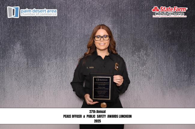 Image of a woman holding an award. 