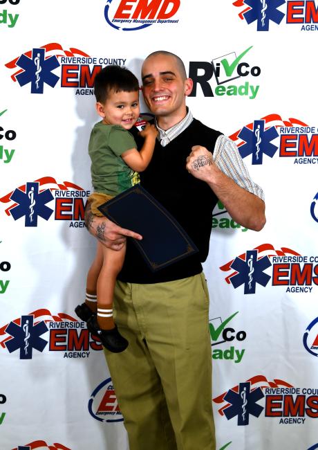 Man standing holding a boy in his arm, 