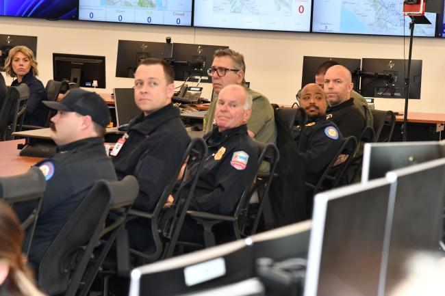 Several people sitting down looking in the same direction. 