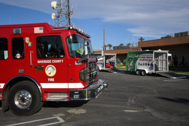 A fire engine and a CERT equipment trailer stand ready for the exercise.