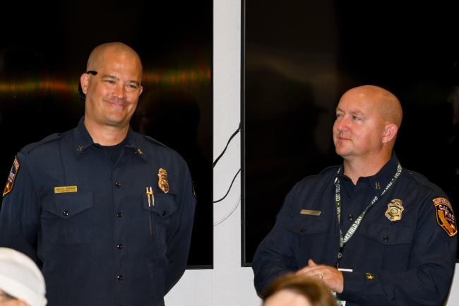 A CAL FIRE Fire Chief and a Fire Captain listen to opening remarks at CERT Field Day.