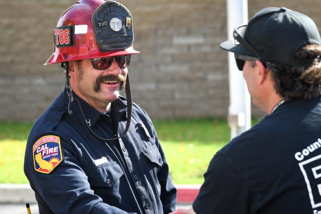 A fire captain talks to an EMD instructor.