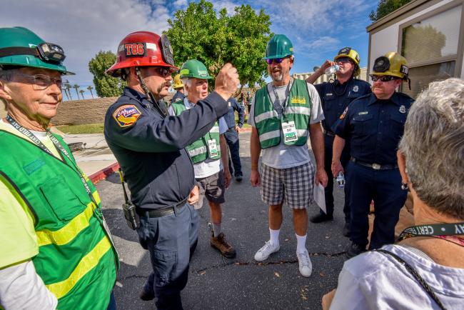 A fire captain talks with several CERT volunteers.