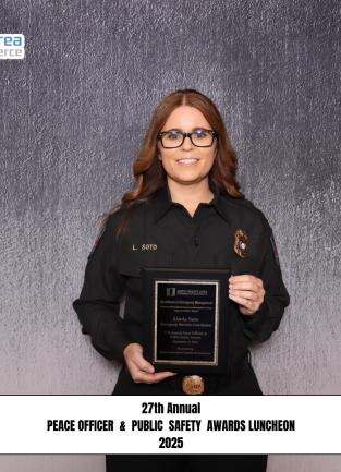 Image of a woman holding an award. 